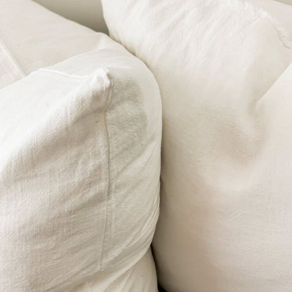 Close-up of white pillows on a neutral background
