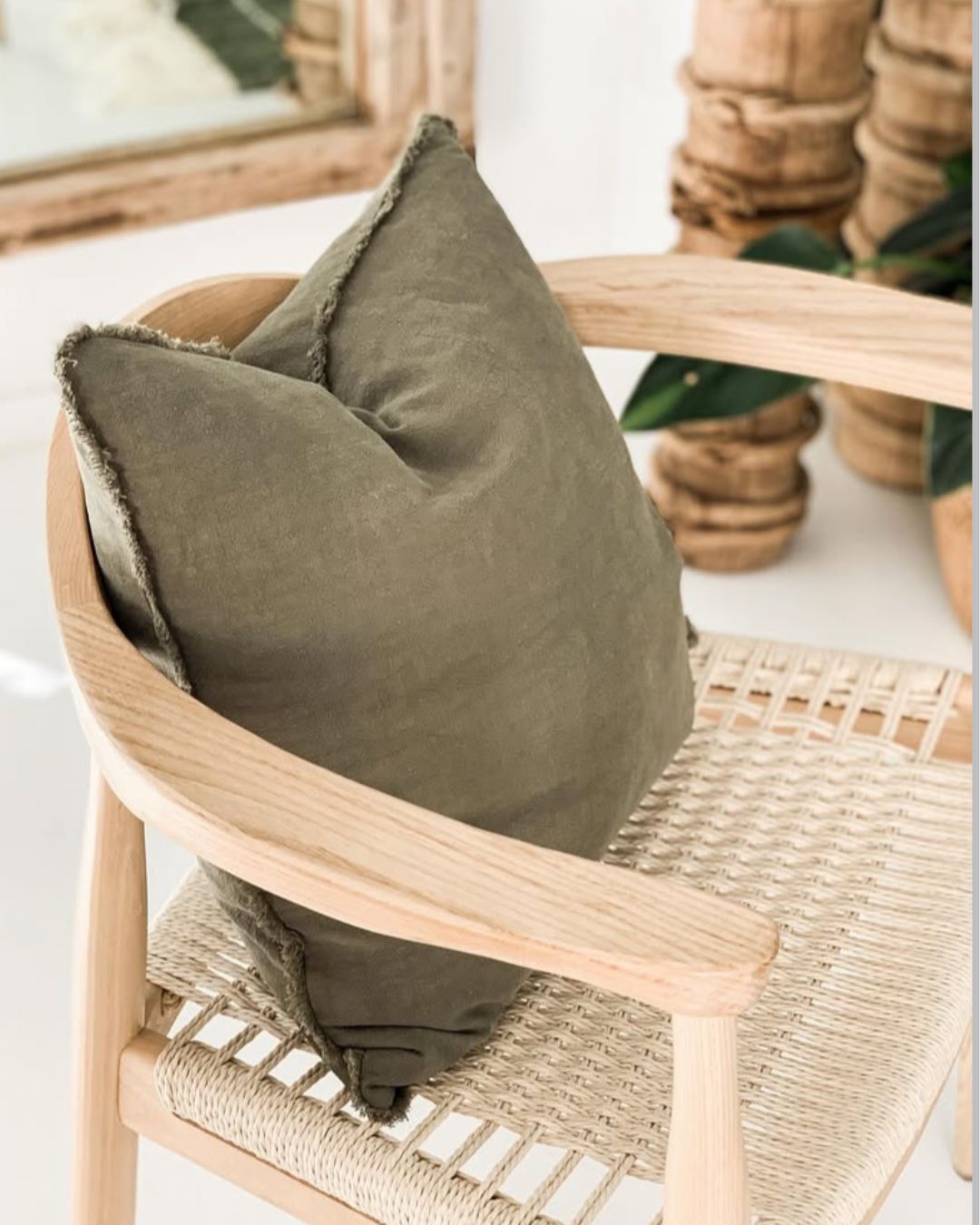 Green cushion on a wicker chair with a blurred background