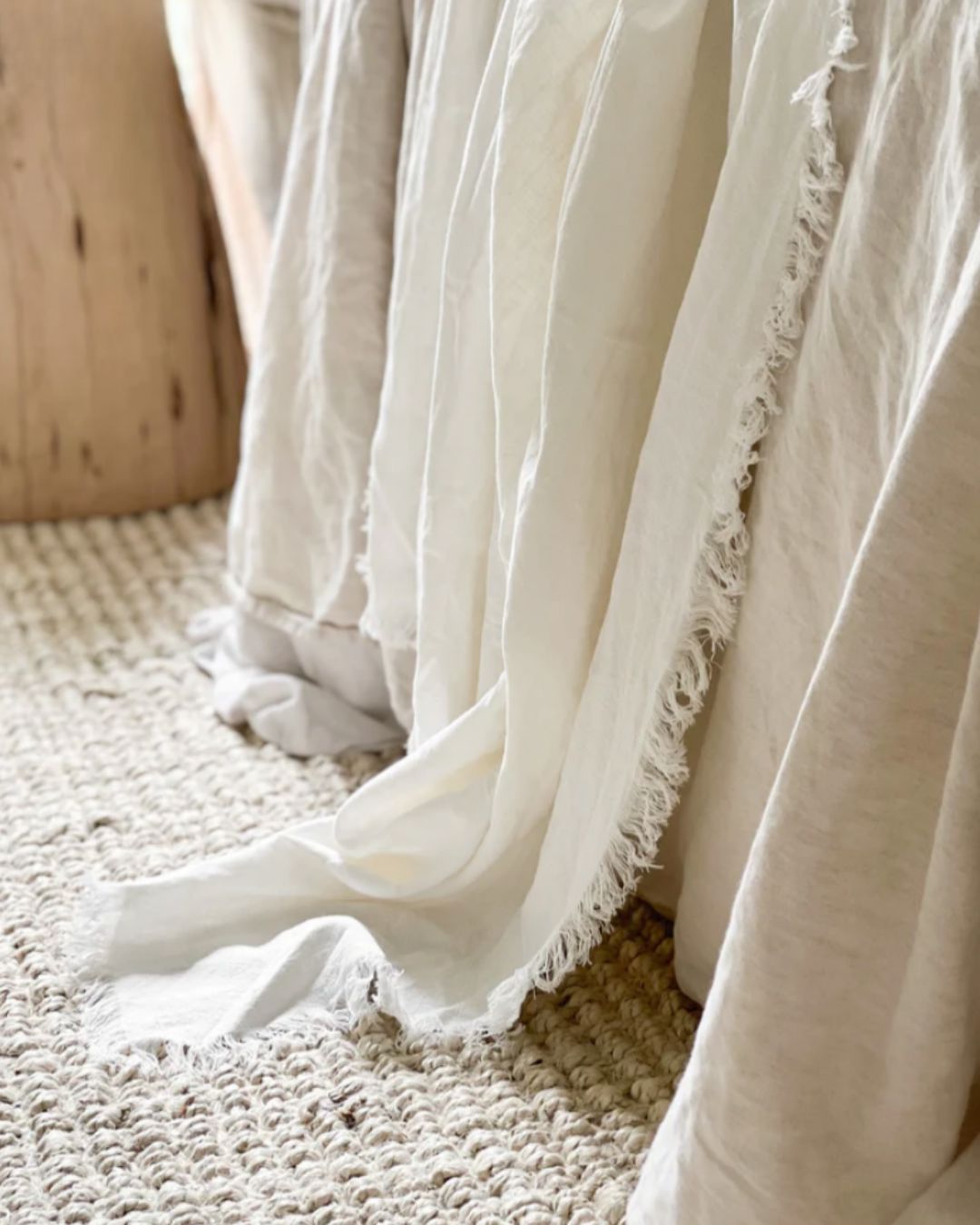 Close-up of a white textured blanket draped over a surface.