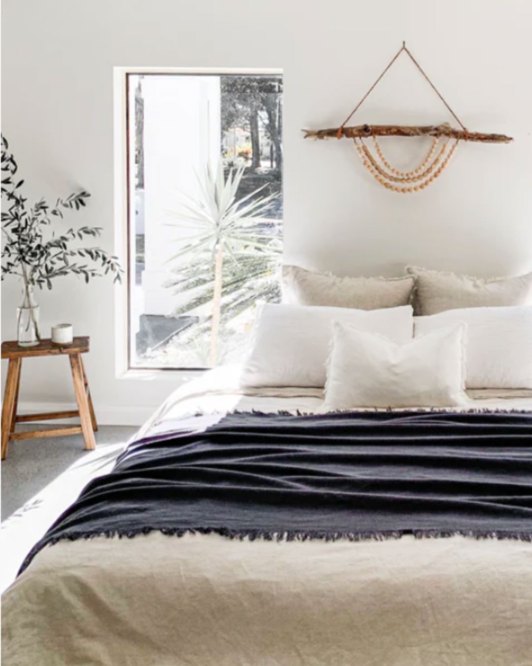 Cozy bedroom with a bed, framed artwork, and decorative elements.
