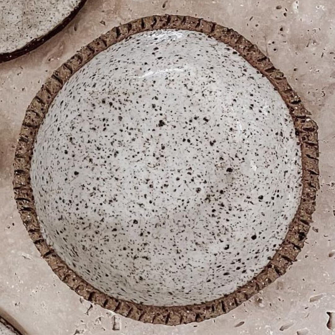 Close-up of a speckled handmade clay dish 