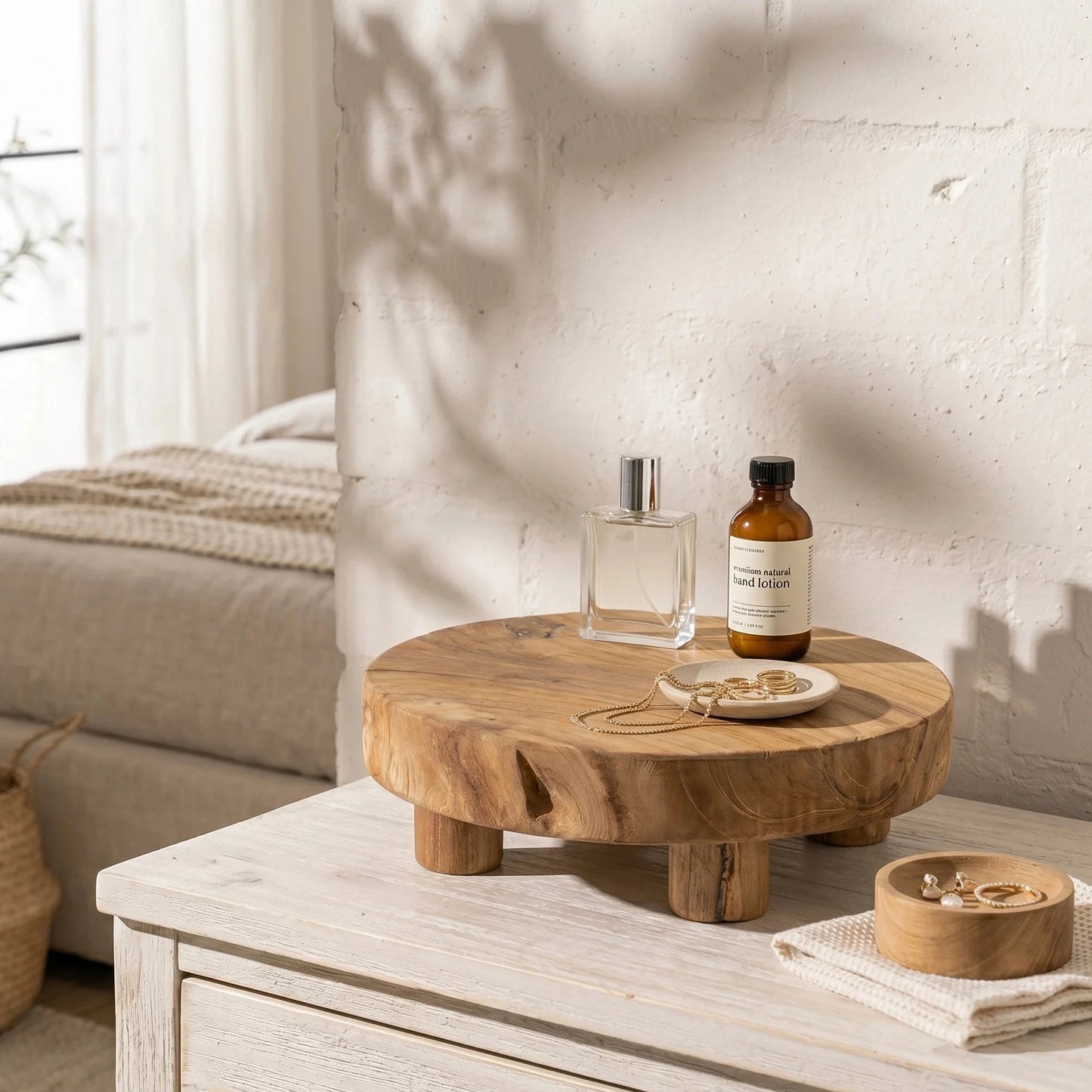 Wooden tray with a bottle and small bowl on a wooden surface in a room with a bed and window.