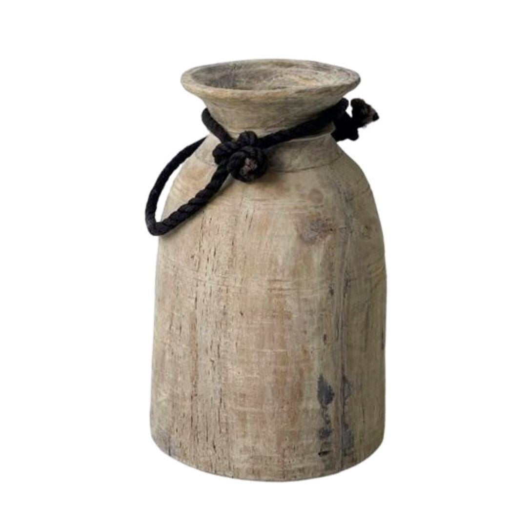Wooden vase with a black rope handle on a white background