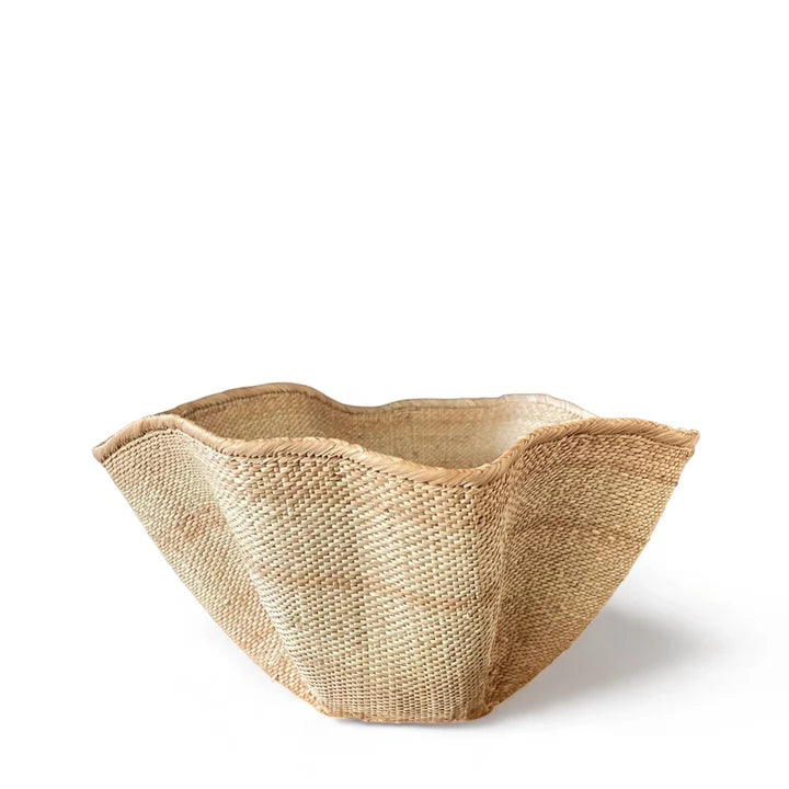 A natural woven jute planter or basket with a wavy, scalloped rim, shown on a clean white background.