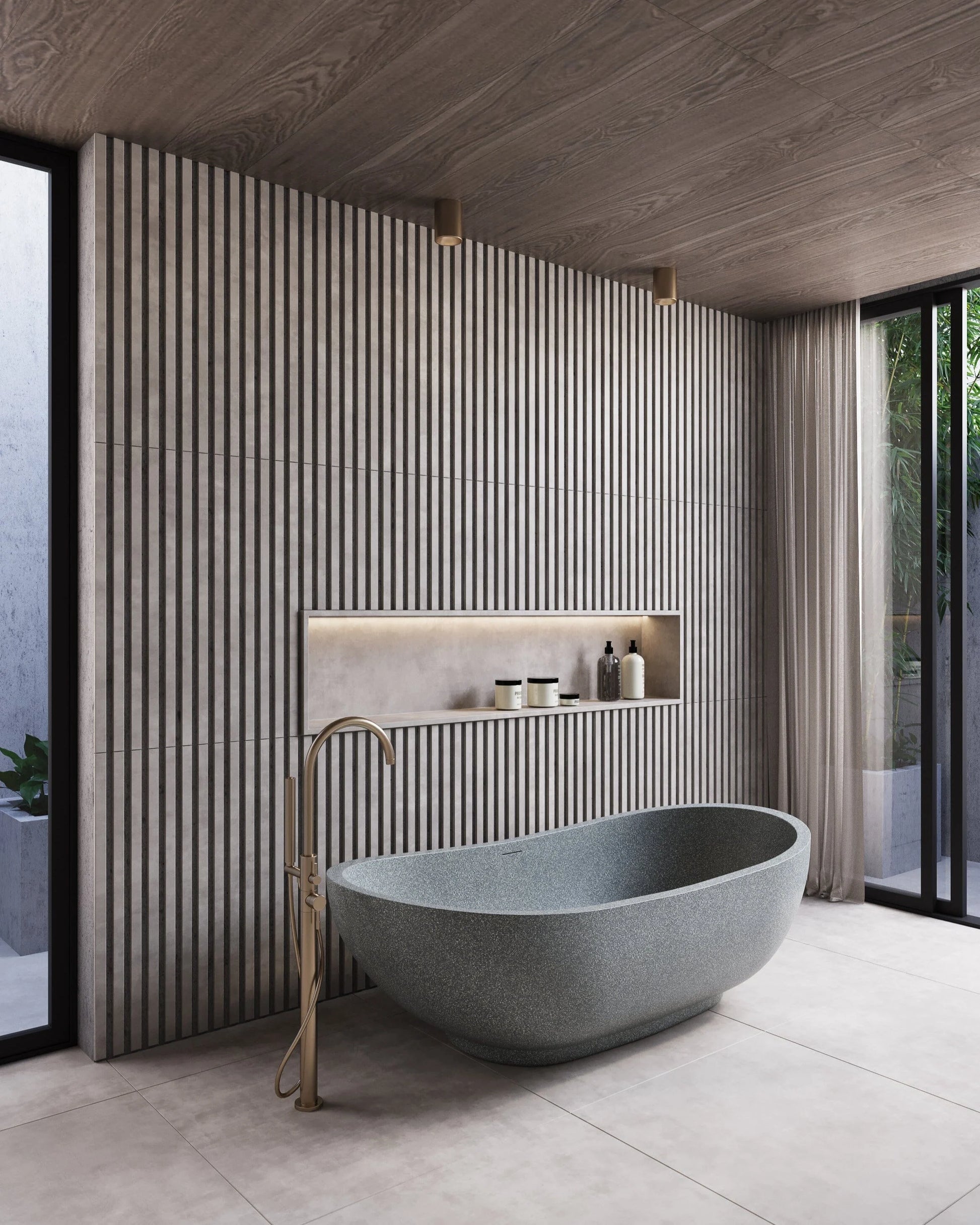 Modern bathroom with a freestanding stone bathtub and striped wall tiles.