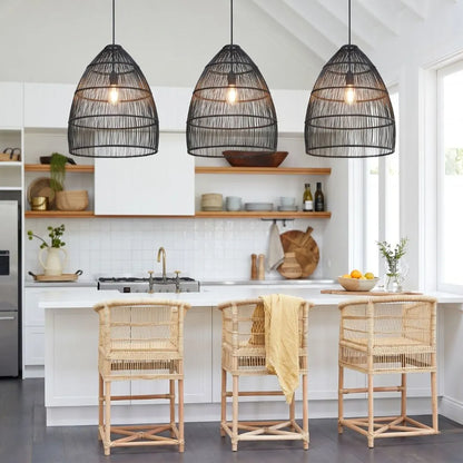 Modern kitchen with black woven pendant lights, wooden chairs, and a white island.