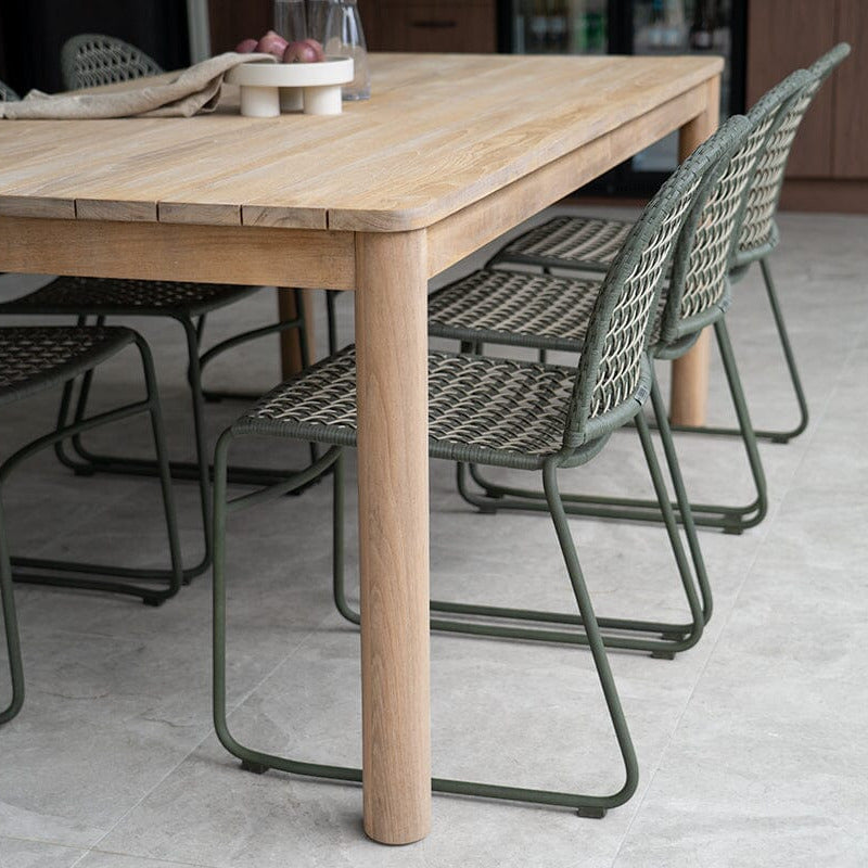 Sun Republic Elsa Teak Outdoor dining table and Zalia Moss green chairs in a outdoor setting